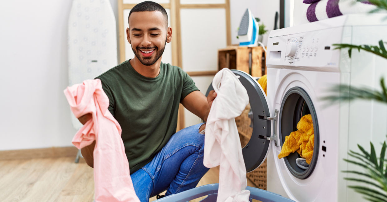 A man washing his clothing in cold water.
