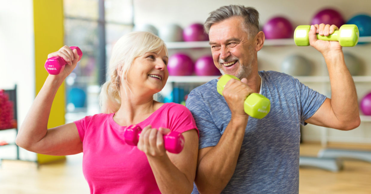 A mature couple lifts weights together, a workout for the body and mind.