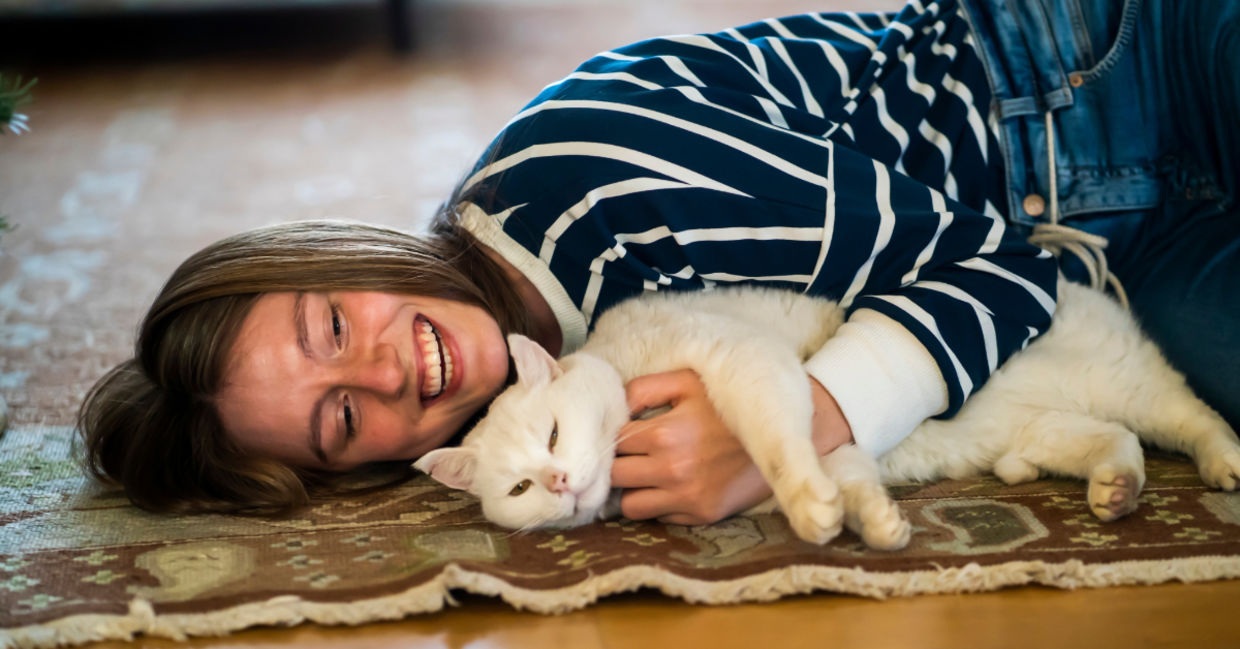 Girl relaxing to the sounds of a purring cat.