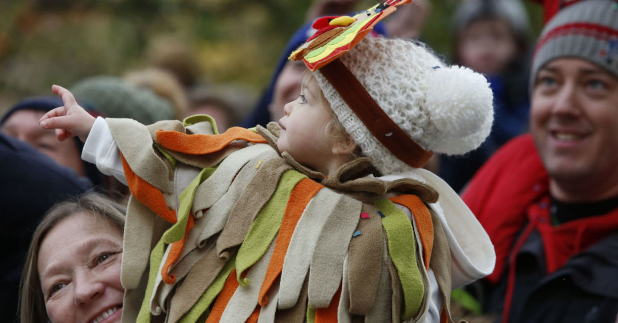 A family watches the Macy's Thanksgiving parade in New York City.