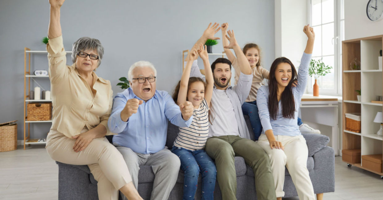 A family watches TV together.
