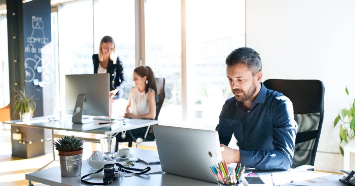 Businesspeople in a sunlit office.