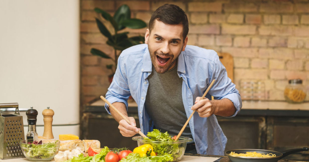 An enthusiastic chef cooks in the kitchen.