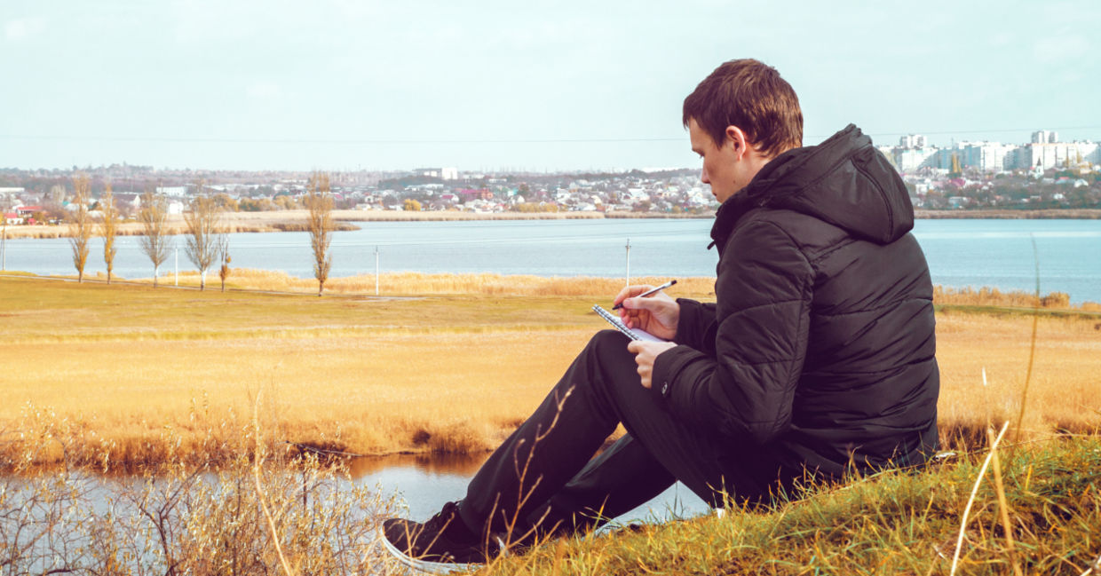 A young man writing a poem.