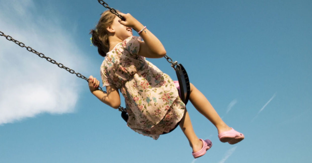 A woman enjoying a swing is a simple pleasure.