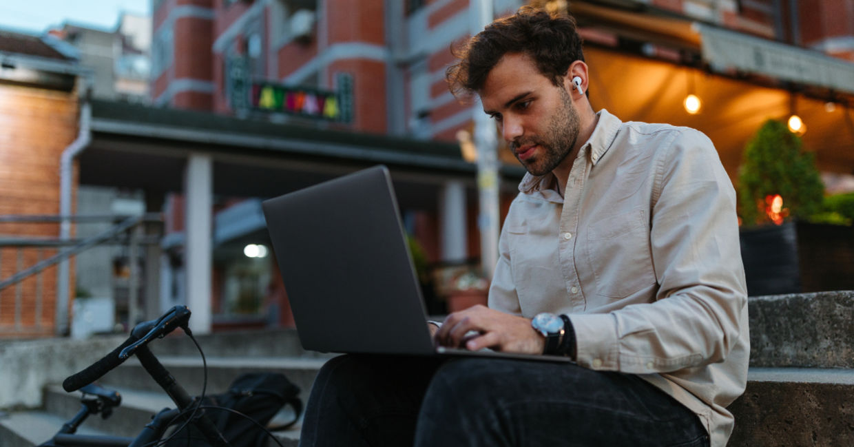 A young man typing on a computer.