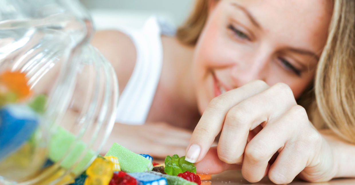A woman eating jelly candies.