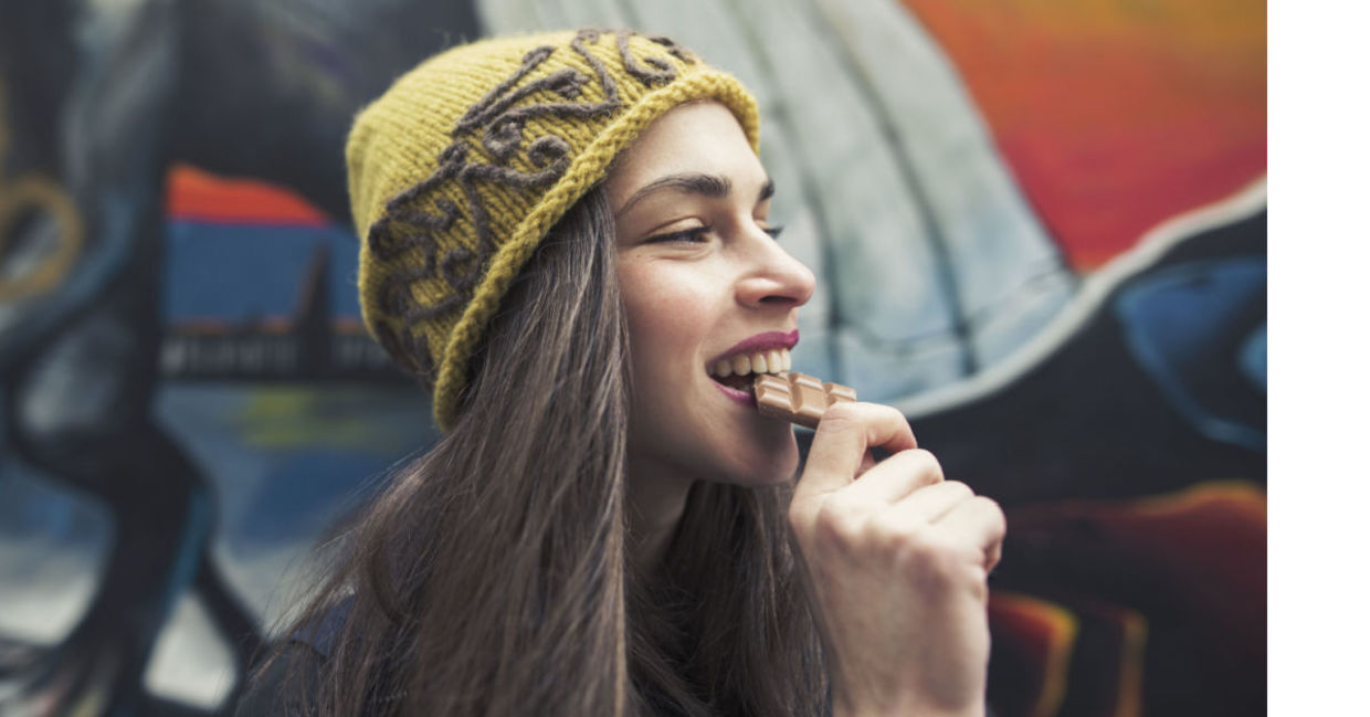 Woman enjoying a chocolate bar.