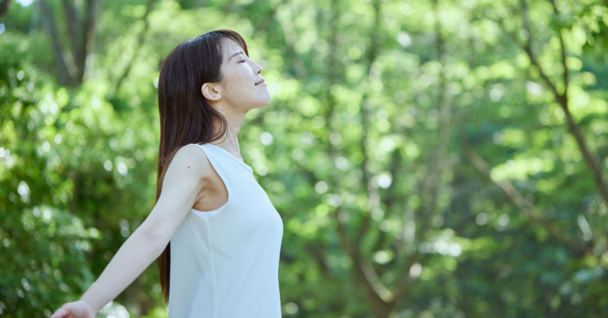 Japanese woman forest bathing.