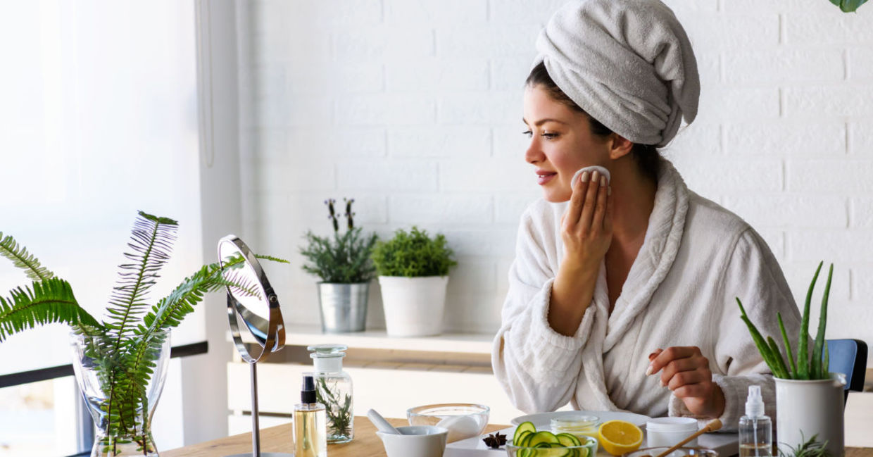 Woman giving herself a facial with DIY beauty products.