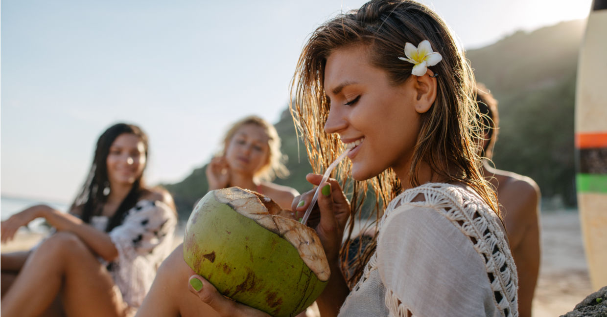 Drinking from a coconut.
