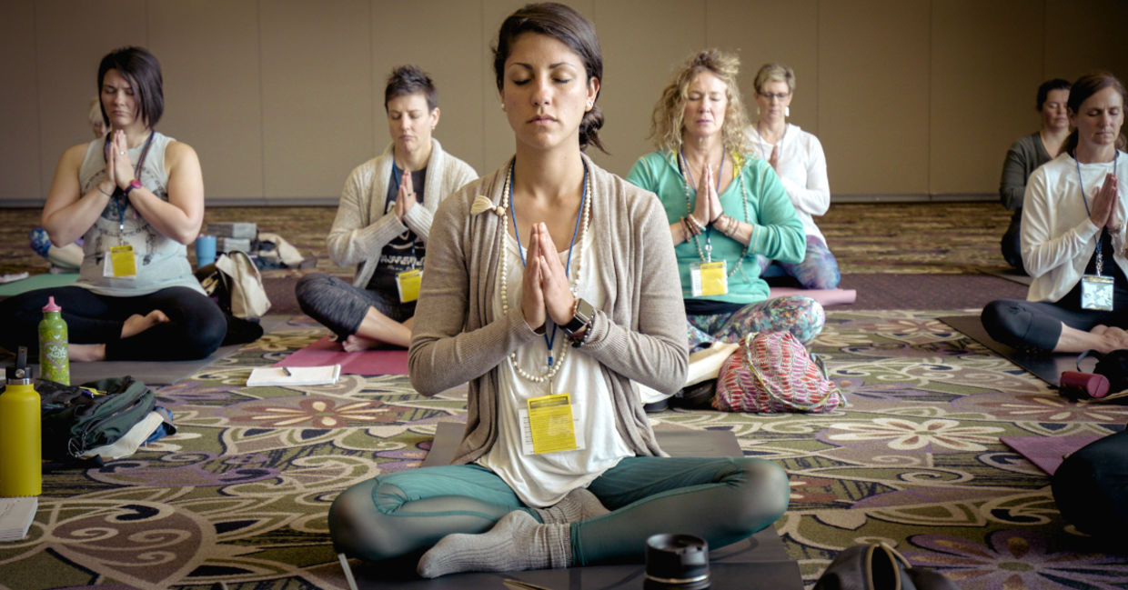 A yoga class in the easy pose.