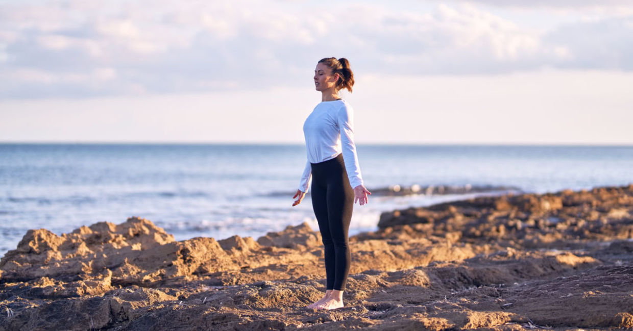 A woman performing the mountain yoga pose.