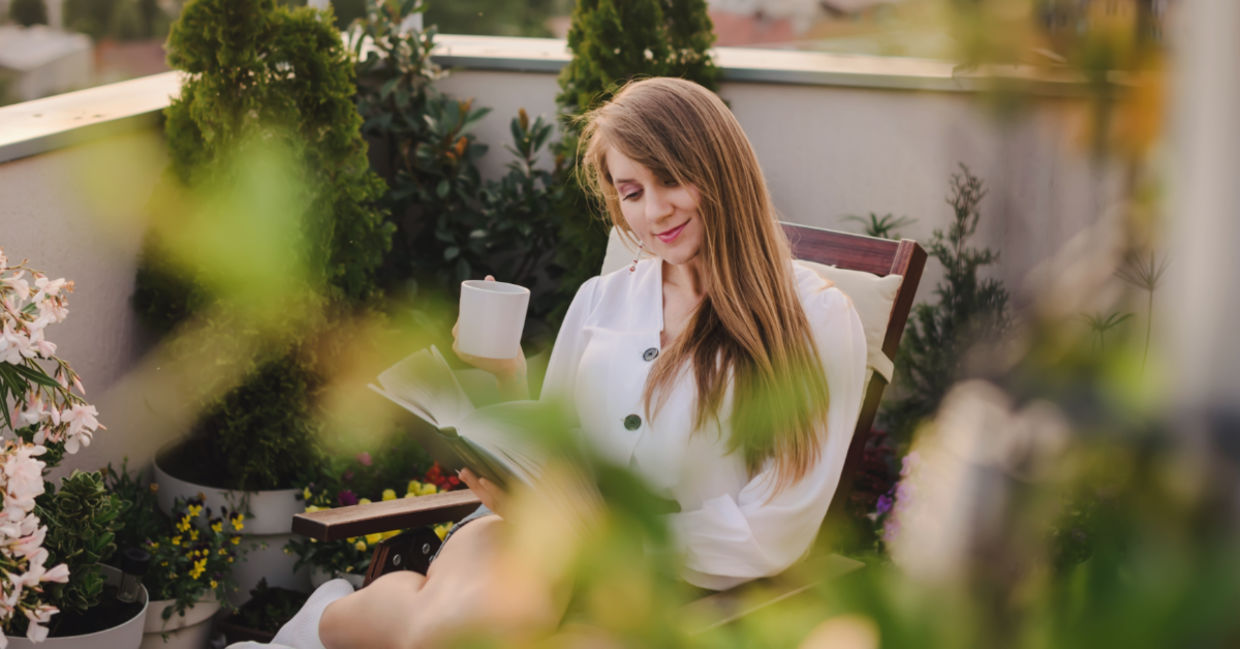 Woman surrounded by greenery.