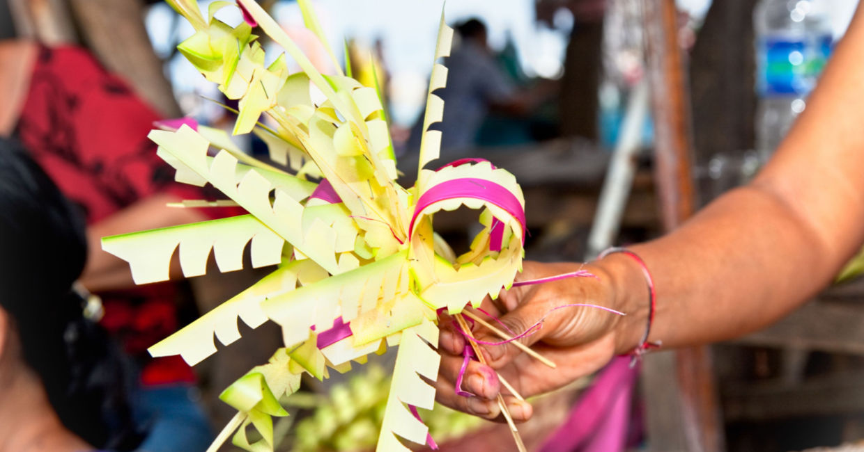 Woman weaving a Canang Sari.