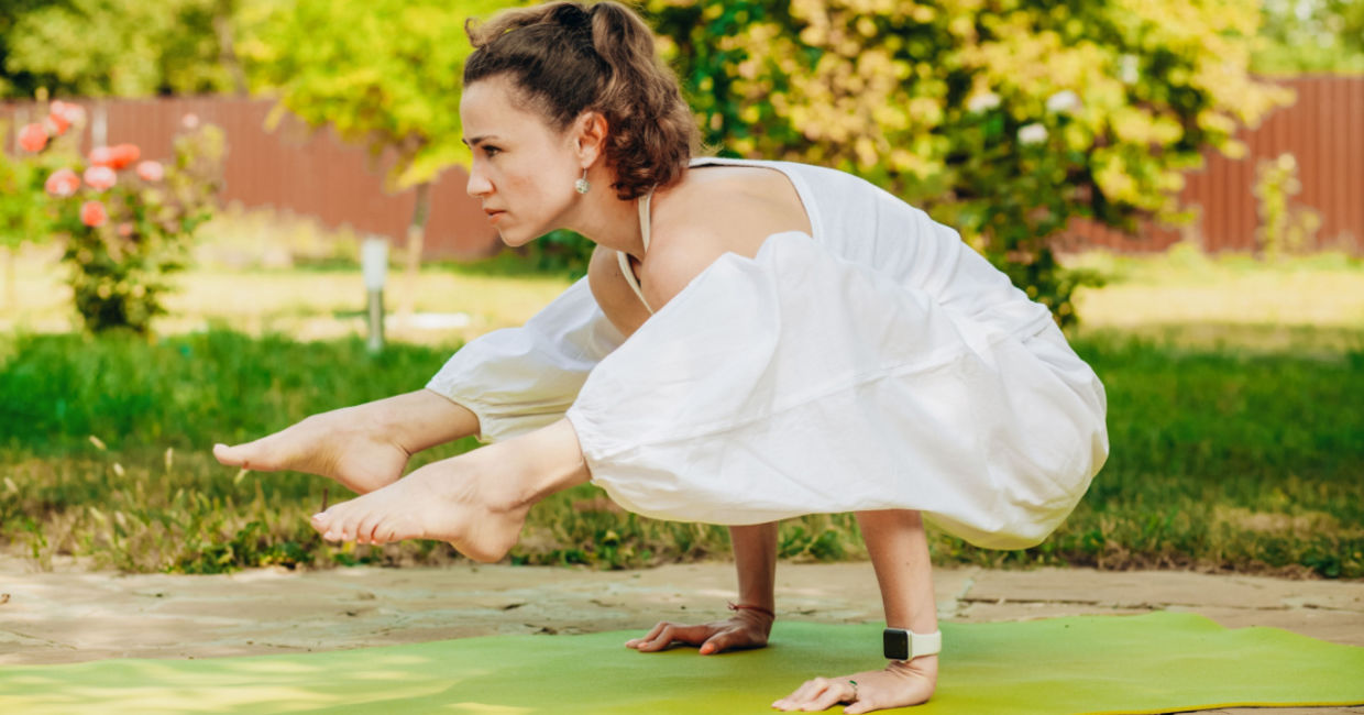 Woman in the firefly yoga pose.