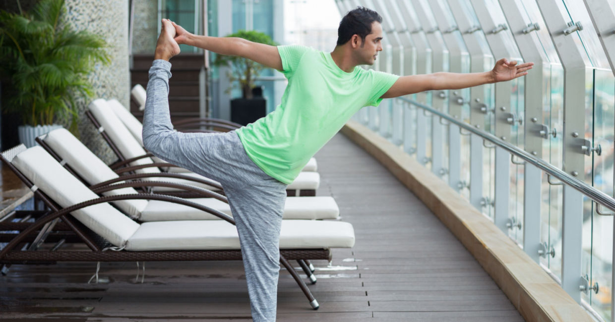 man doing the dancing shiva yoga pose.