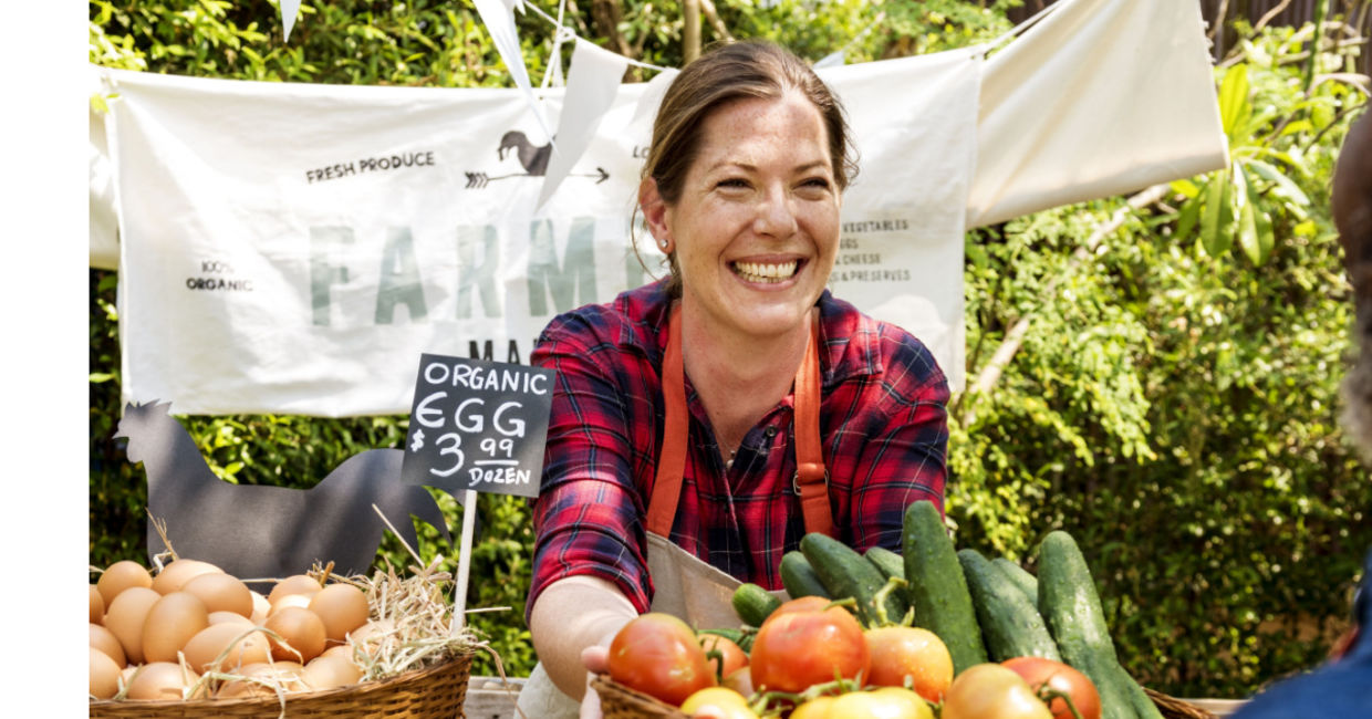 Women selling produce at a famers market.