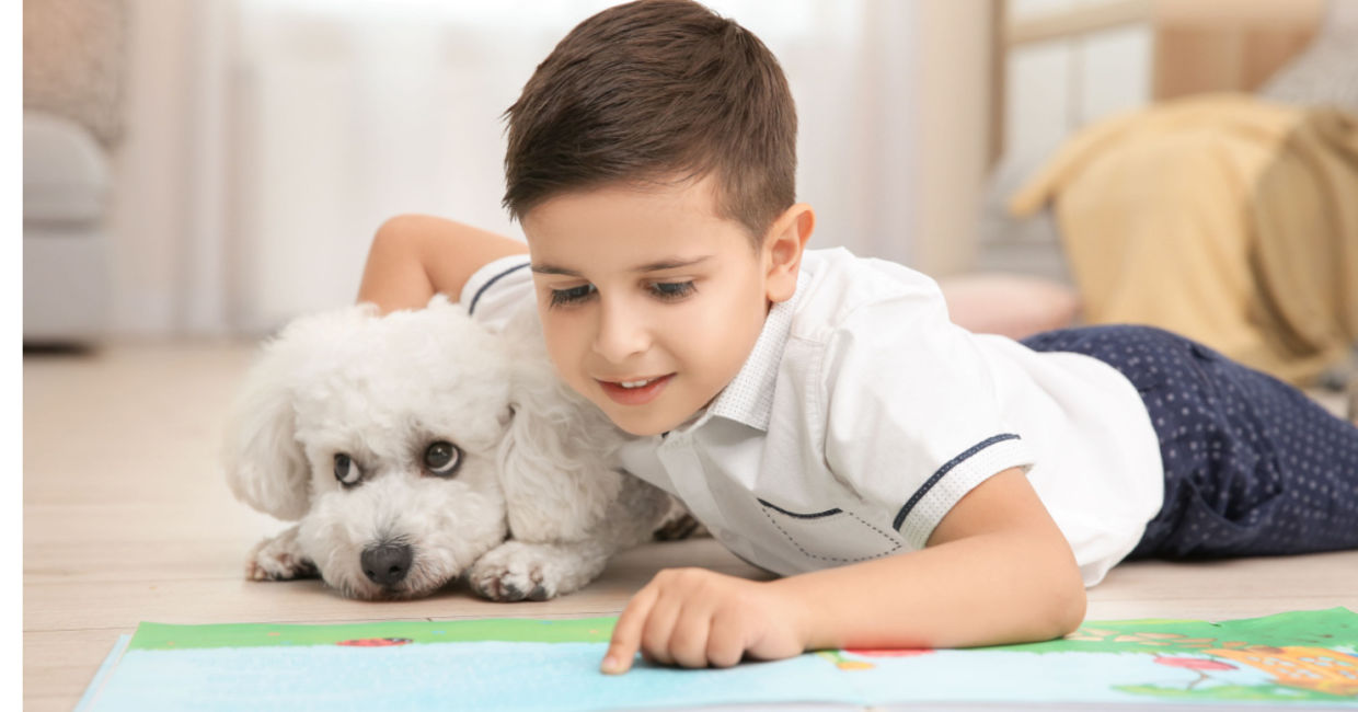 Little girl reading to her pet.