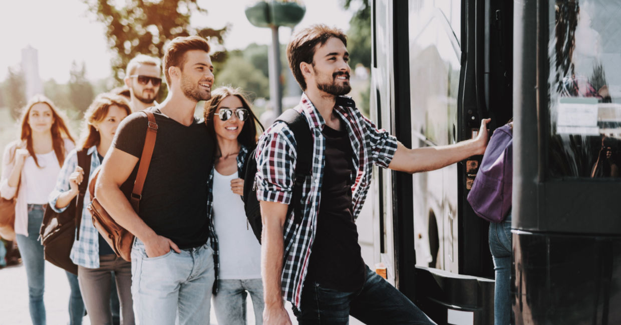 Passangers getting on a bus.