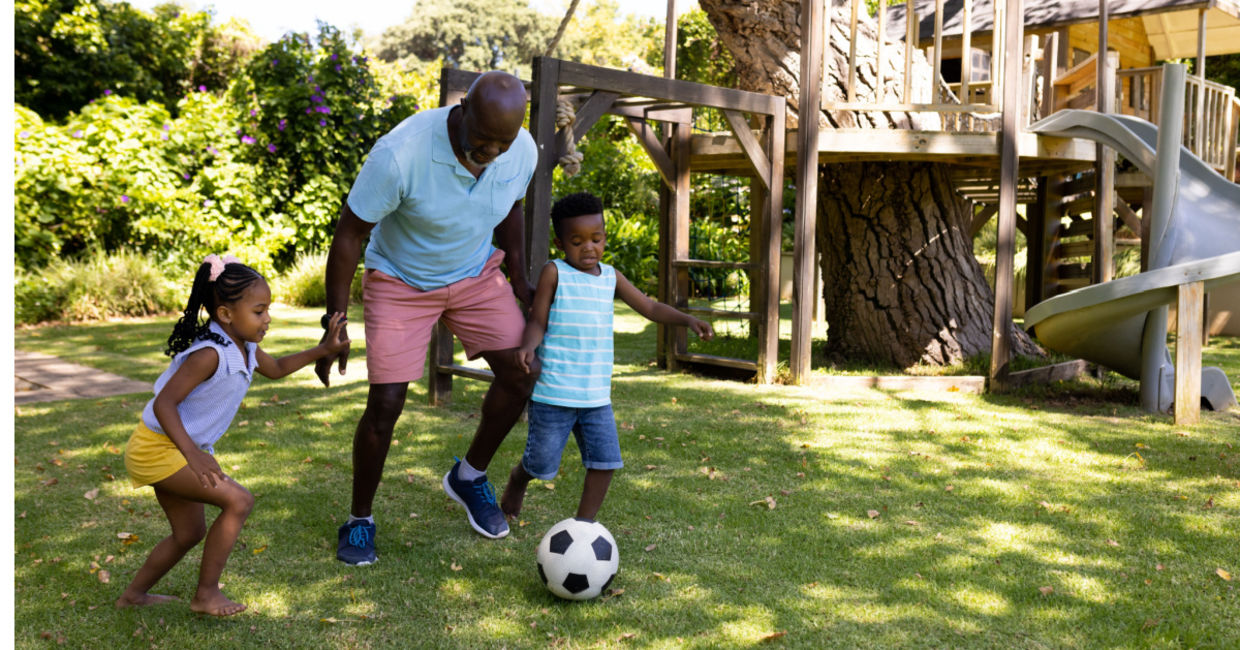 Teaching the grandchildren how to play soccer.