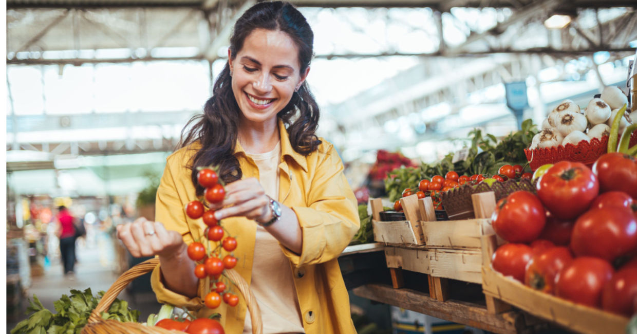 Buying tomatoes at a farmers market.