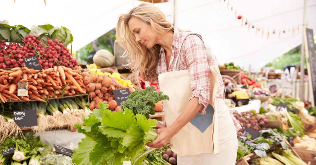 Woman buying vegetables at a farmer's market.
