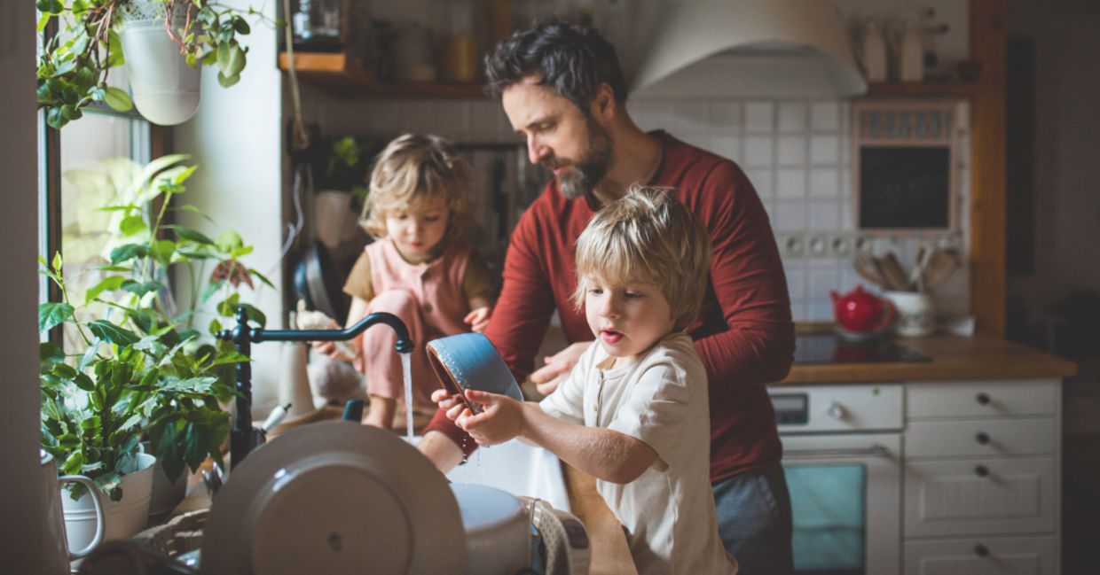 Father and sons washing dishes.