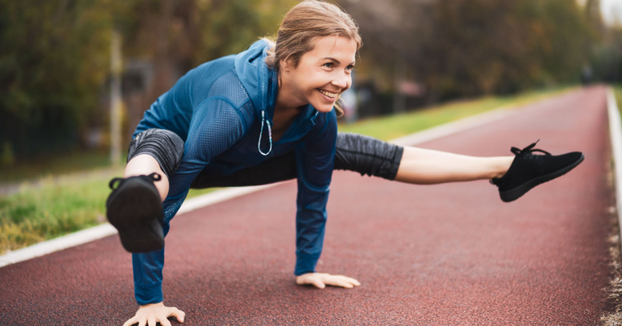 A woman in the firefly yoga pose.
