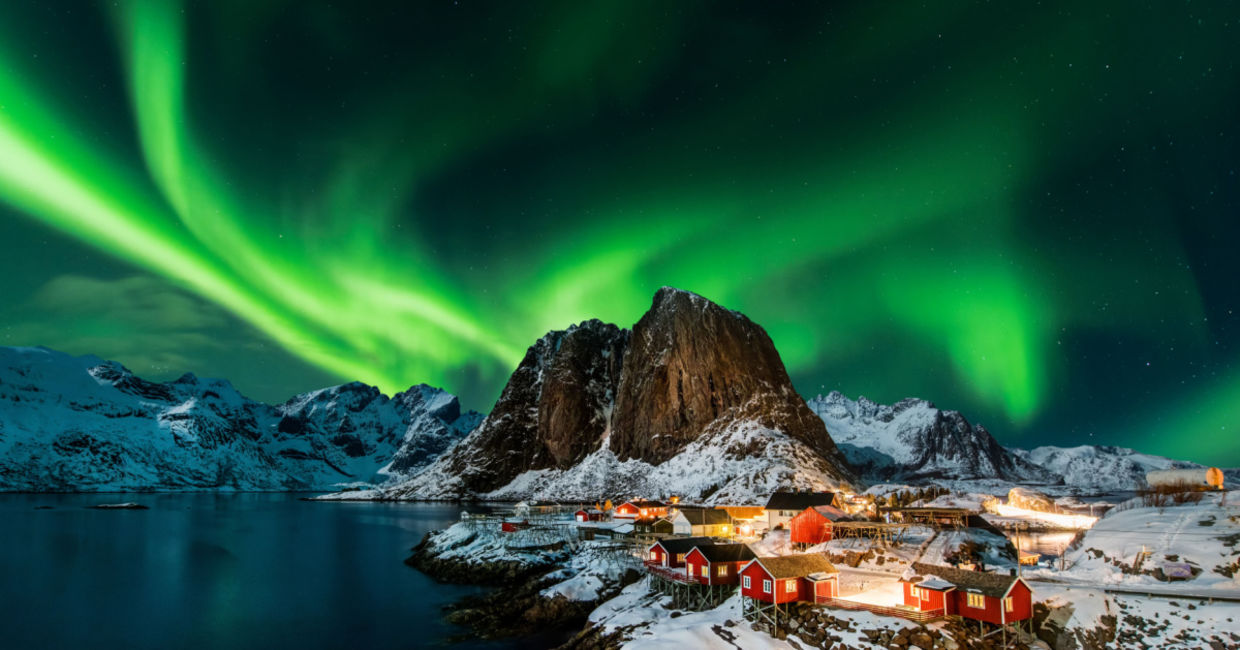 Aurora borealis over Hamnoy in Norway .