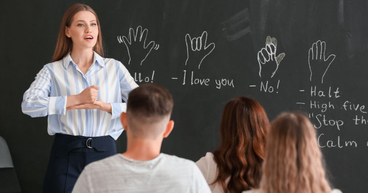 Teacher instructing a class on signing.