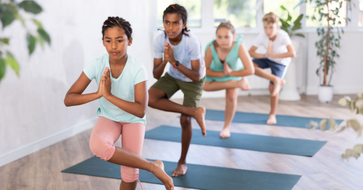 Teens learning the eagle pose.