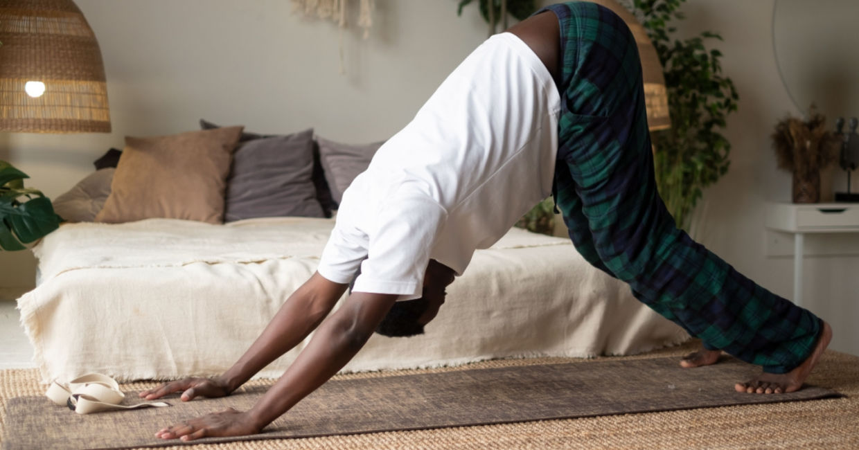 Man doing the downward dog yoga pose.