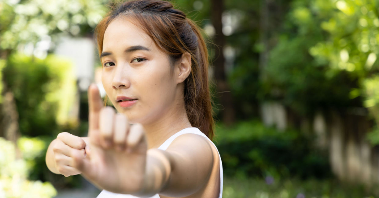 Woman performing the drawing the bow brocade.