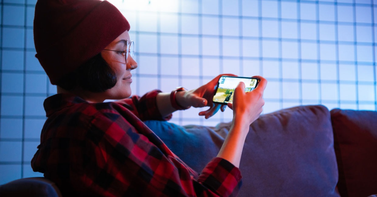 Playing  game on a cellphone.