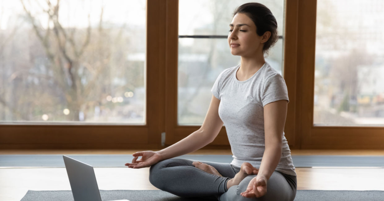 Woman beginning a series of yoga poses to help her get over a cold.