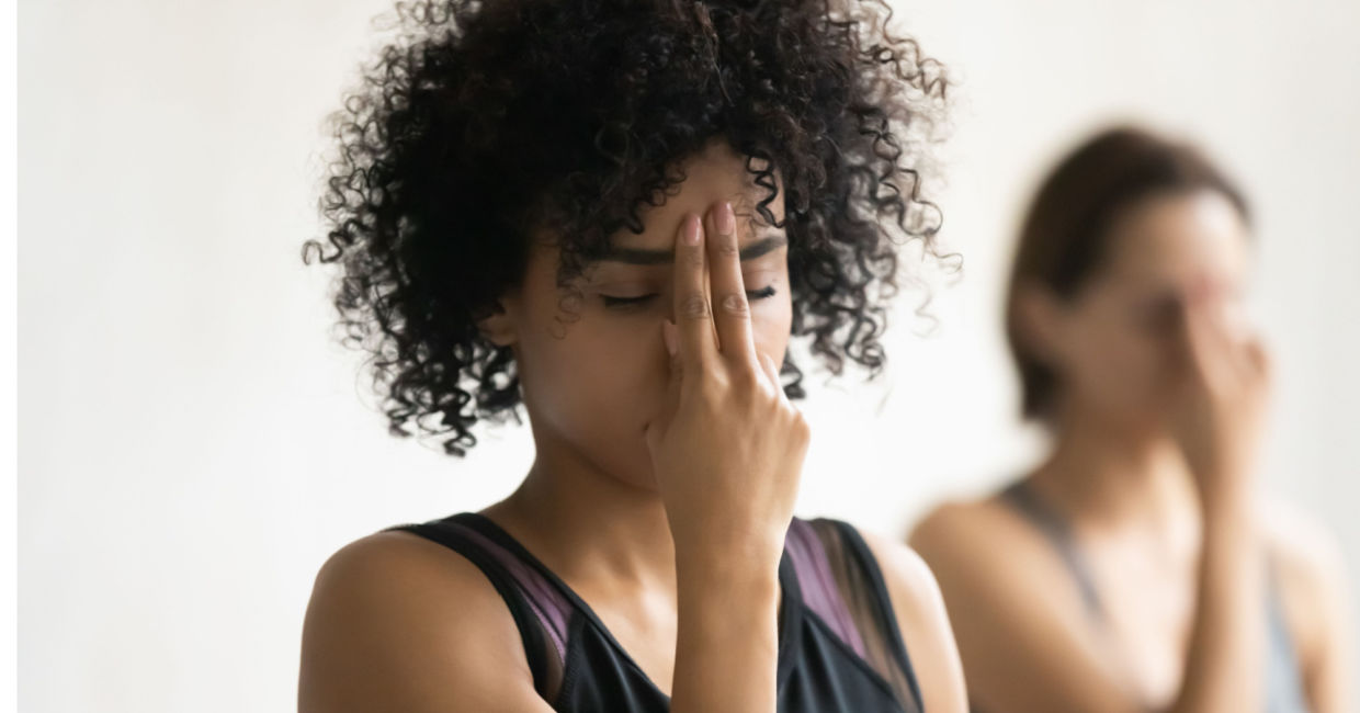 Women practicing pranayama deep breathing.