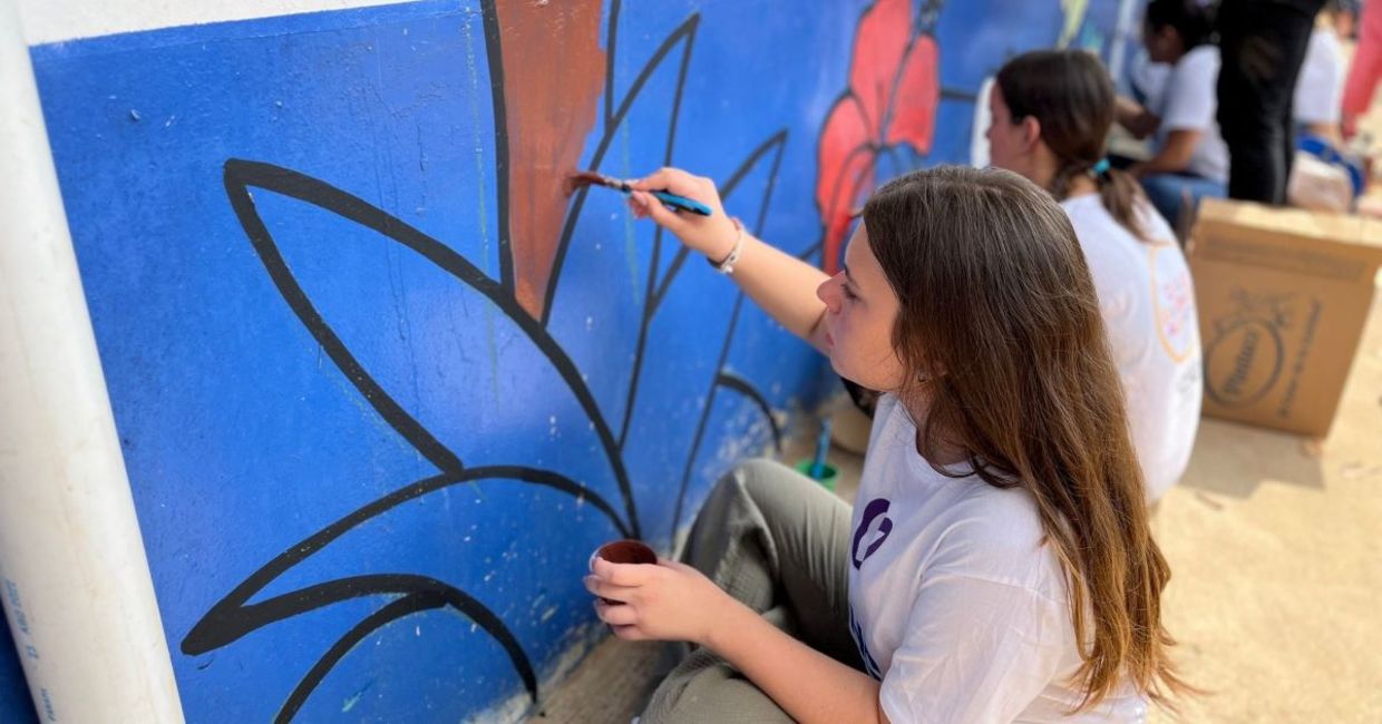 Painting a mural in Panama on Good Deeds Day.