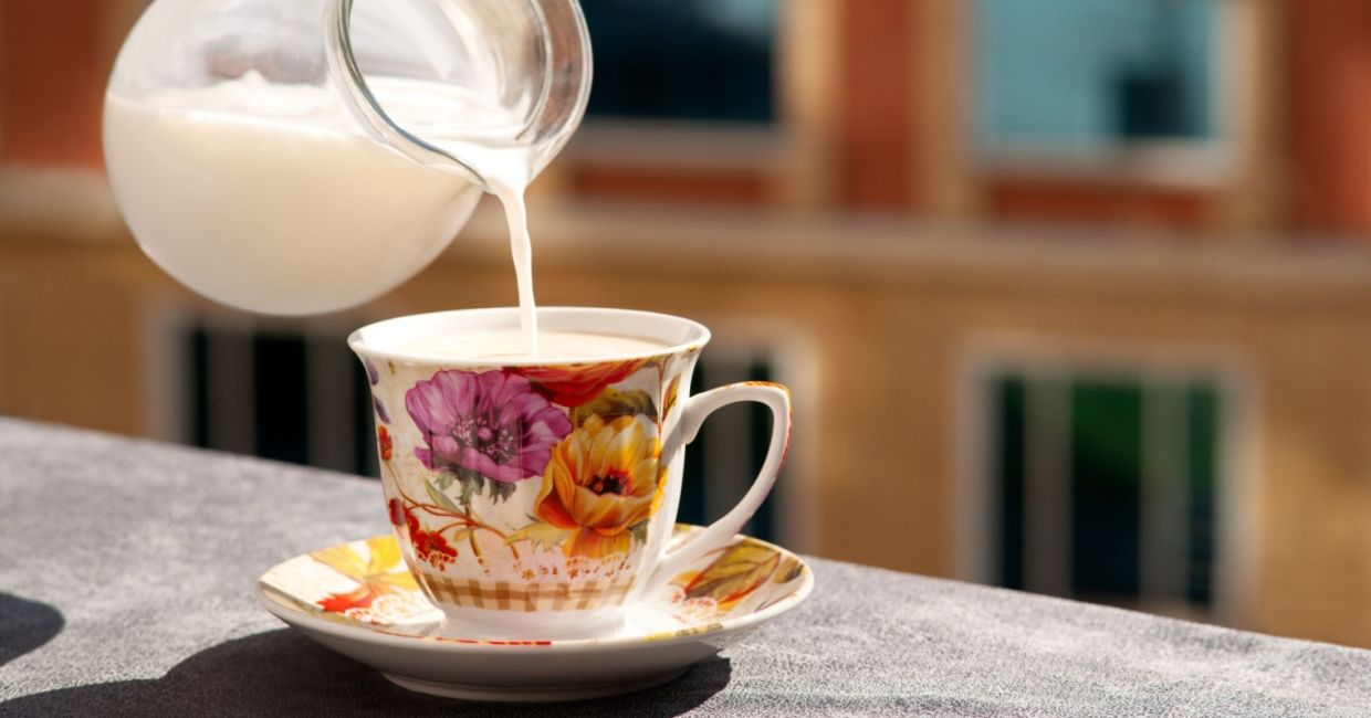 Pouring nondairy milk into a cup of tea.