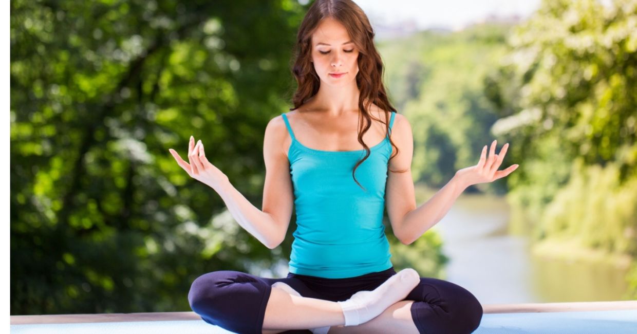 Doing yoga in a park.