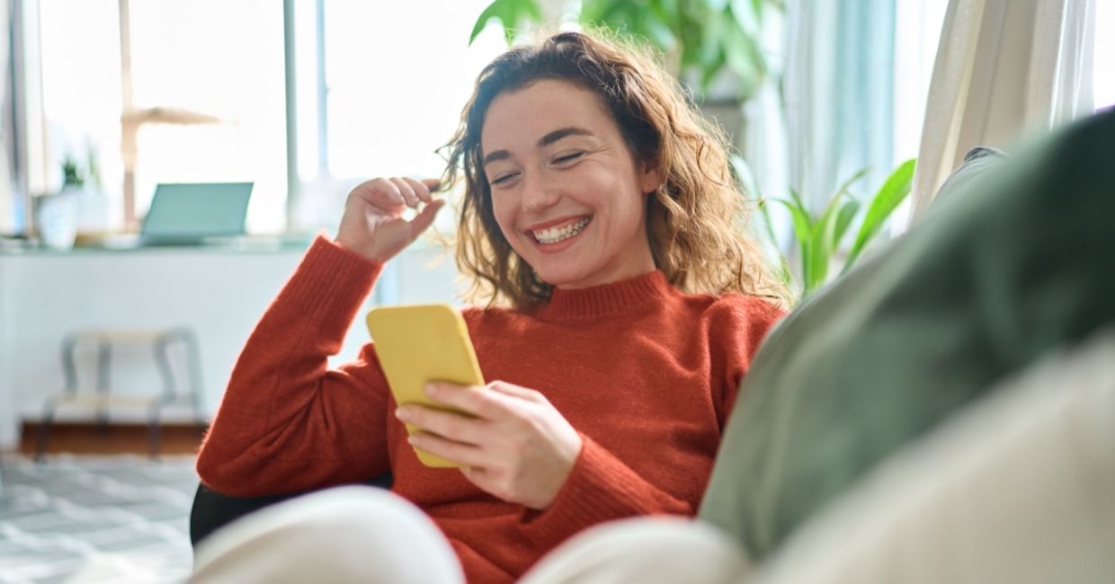 Happy and relaxed young woman working from home.
