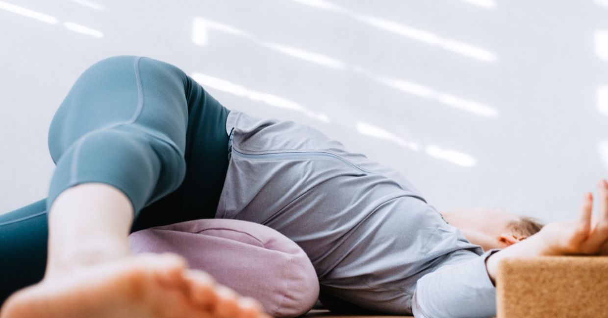 Practicing the supine twist yoga pose.