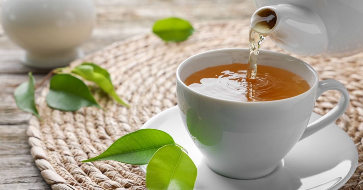 Pouring a cup of green tea.