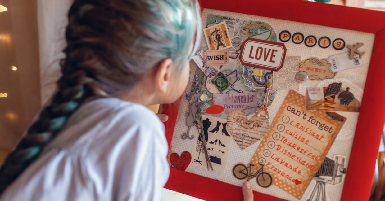 A vision board idea for travel to France is made by a woman who wants to manifest travel.