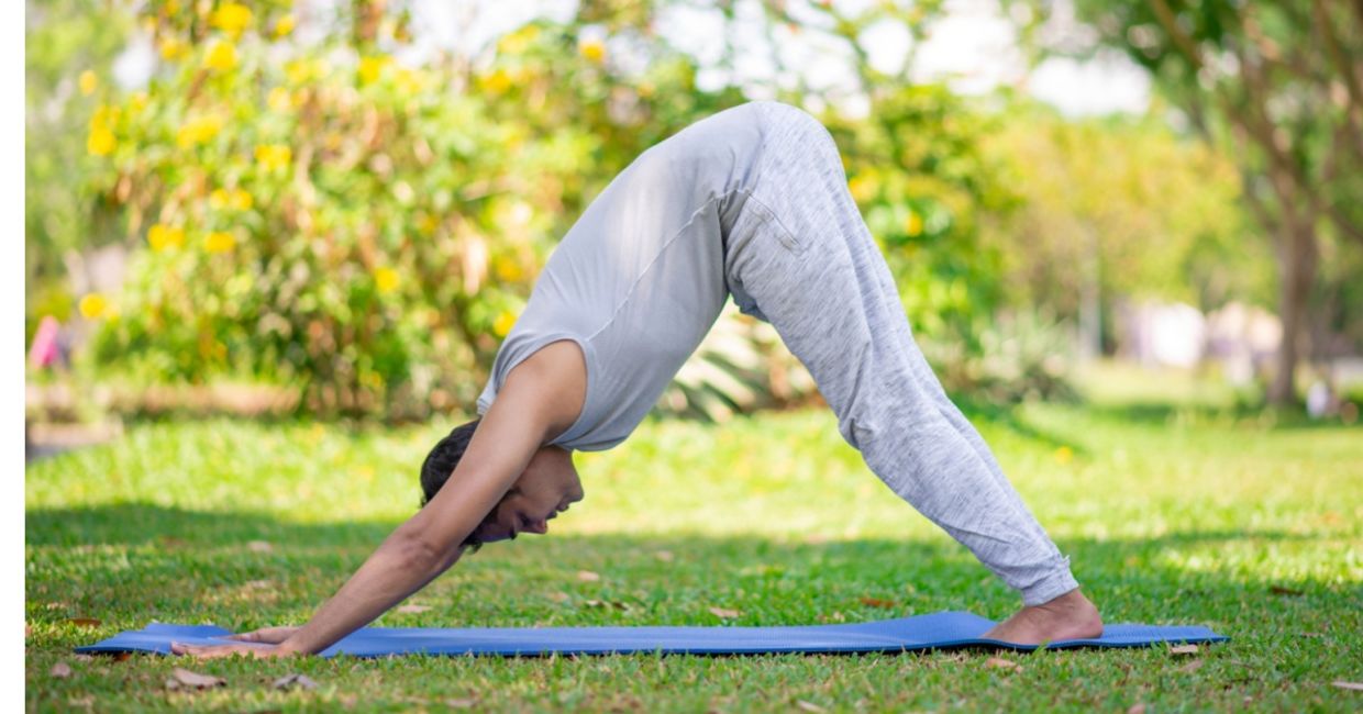 man in the downward facing dog yoga pose.