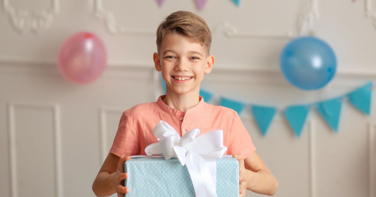 Cute boy bearing a gift.