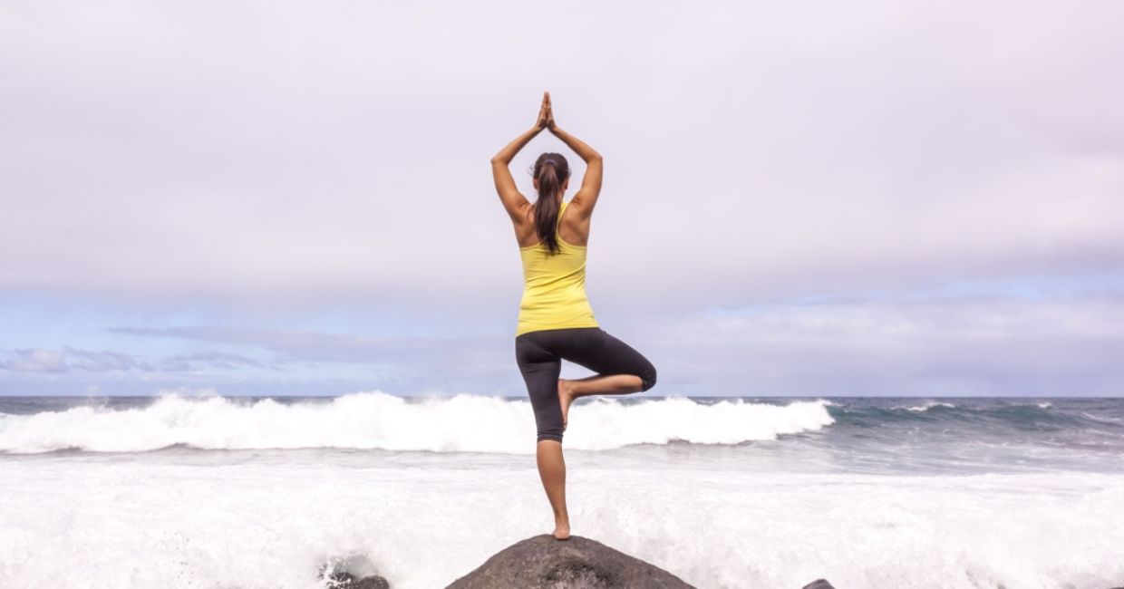 In the tree yoga pose at the beach.
