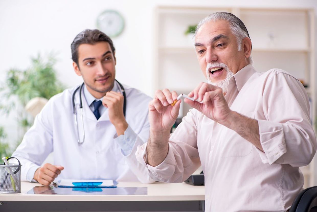 Doctor advising patient to quit smoking.