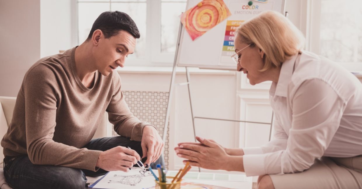 A young man in an art therapy session.