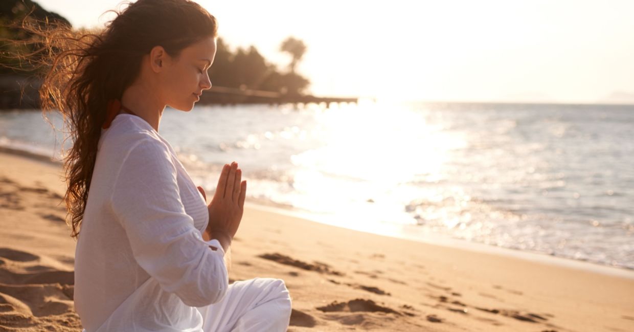 Practicing meditation on a beach.